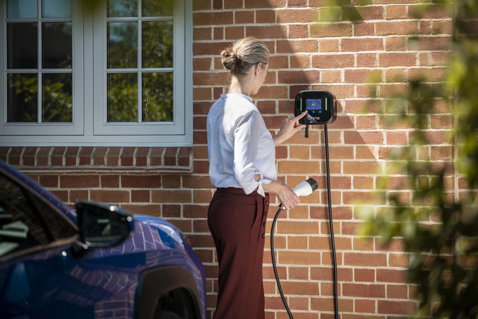Ohme smart EV charger installed on a home wall